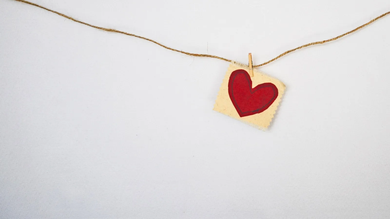 Heart-shaped red and beige pendant
