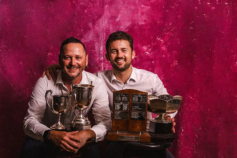 Two Evertsdal members with the club's Western Province trophies